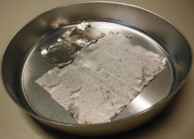 Indium ribbons pressed into the bottom of an aluminum pans