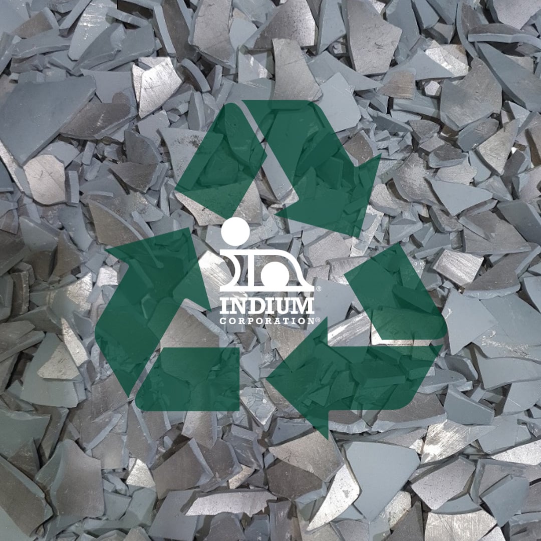 A recycling symbol with the Indium Corporation logo on top of scrap metal sent to reclaim and recycle indium, and gallium.