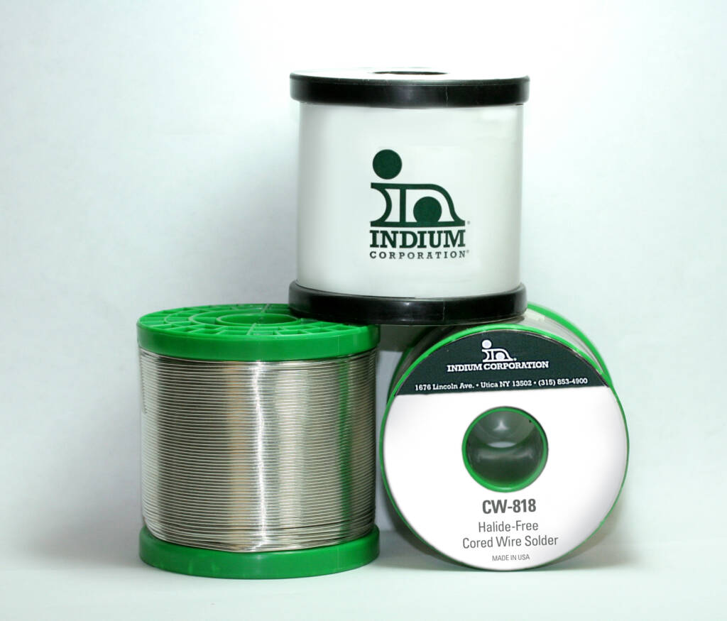 Three spools of solder wire from Indium Corporation, with green and white labels, are stacked together.