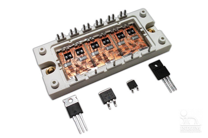 Various types of electronic transistors, a circuit board, and a semiconductor die on a white background.