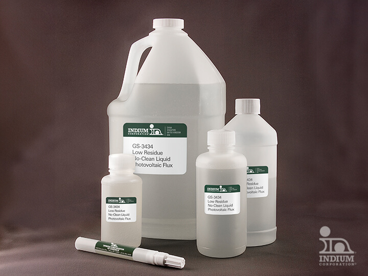 Bottles and containers of Indium GS-3434 Low Residue No-Clean Liquid Photovoltaic Flux on a dark background.