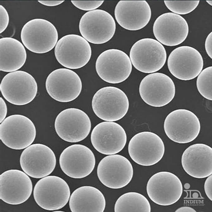 Microscopic view of uniform, spherical particles arranged on a dark background.